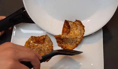 A cheese fritter sliding out of a P600 pan
