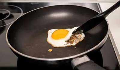 An egg sticking in another pan