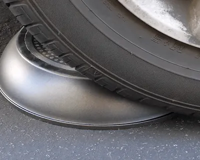 A car tyre rests on the base of a P600 ceramic pan