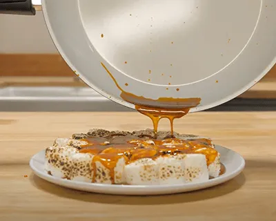 Caramel pours cleanly out of the P600 ceramic pan onto a dessert
