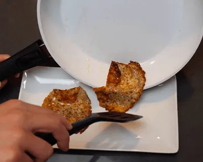 A cheese fritter slides out of the P600 ceramic pan