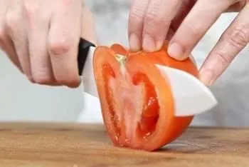 6 inch P600 utility knife slicing a tomato